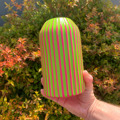 A hand painted fuchsia based vase with green stripes