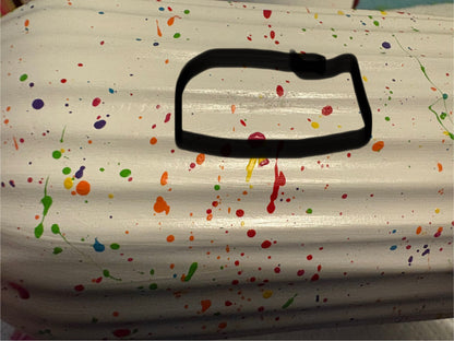 A ceramic rainbow splatter vase with a slight blemish where the primer hasn't covered well. This area is circled with a black marker.