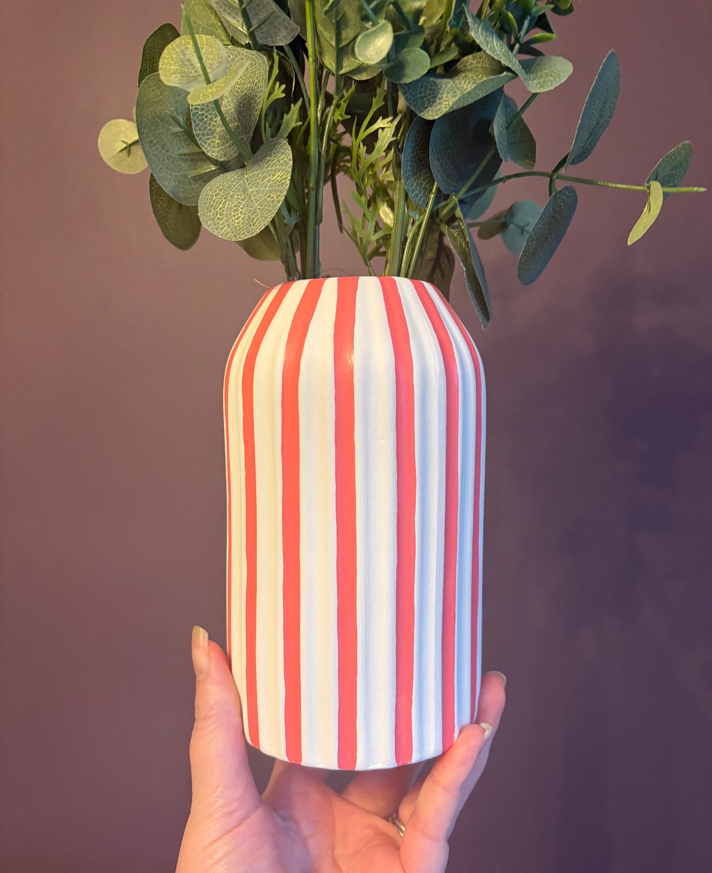 A hand painted white and coral pink striped vase