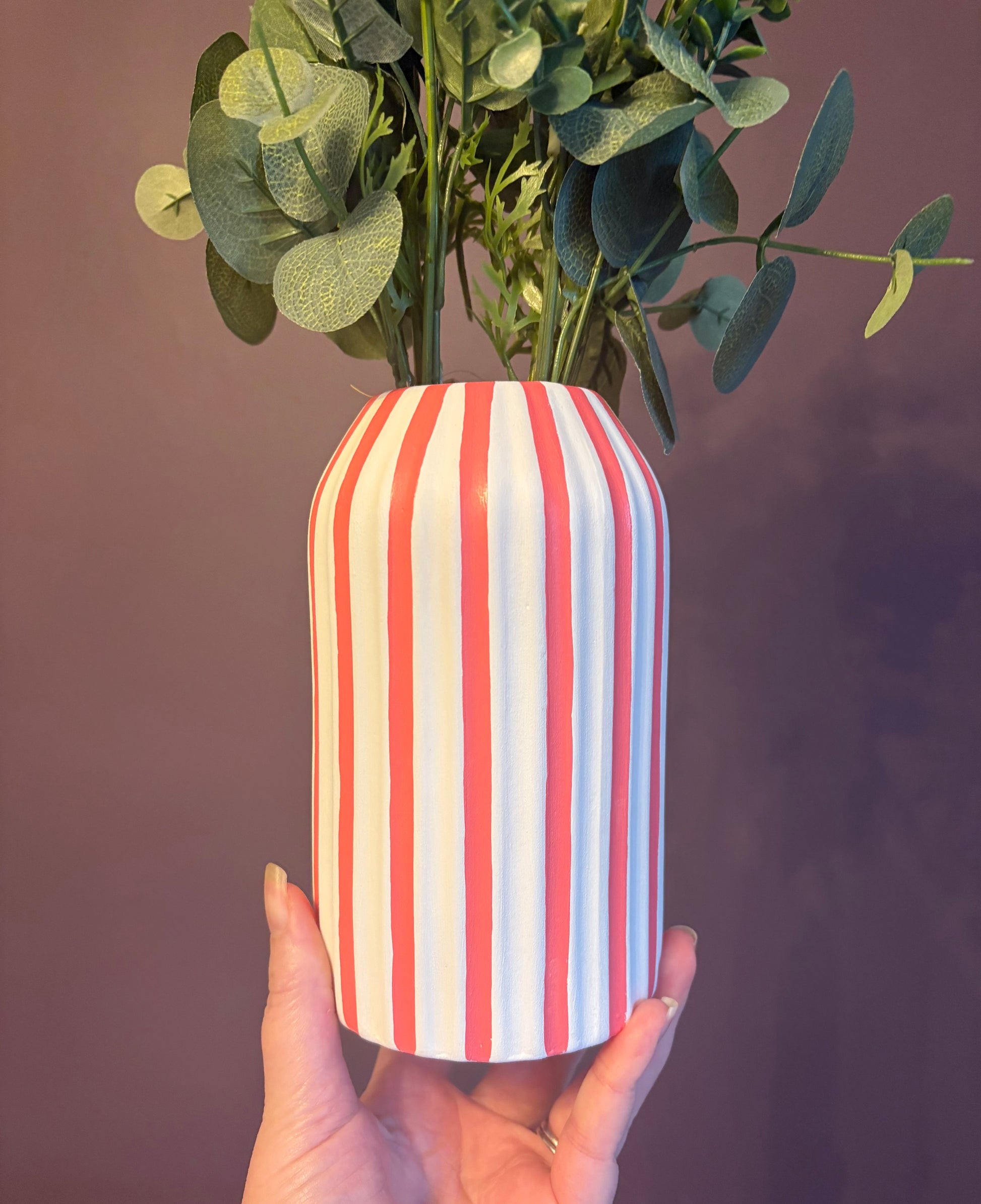 A hand painted white and coral pink striped vase