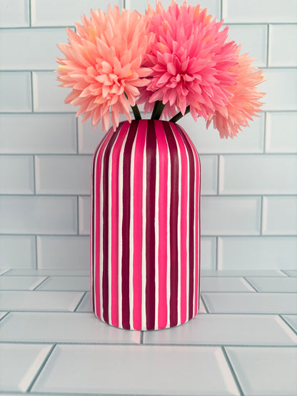 A hand painted fuchsia and plum striped vase