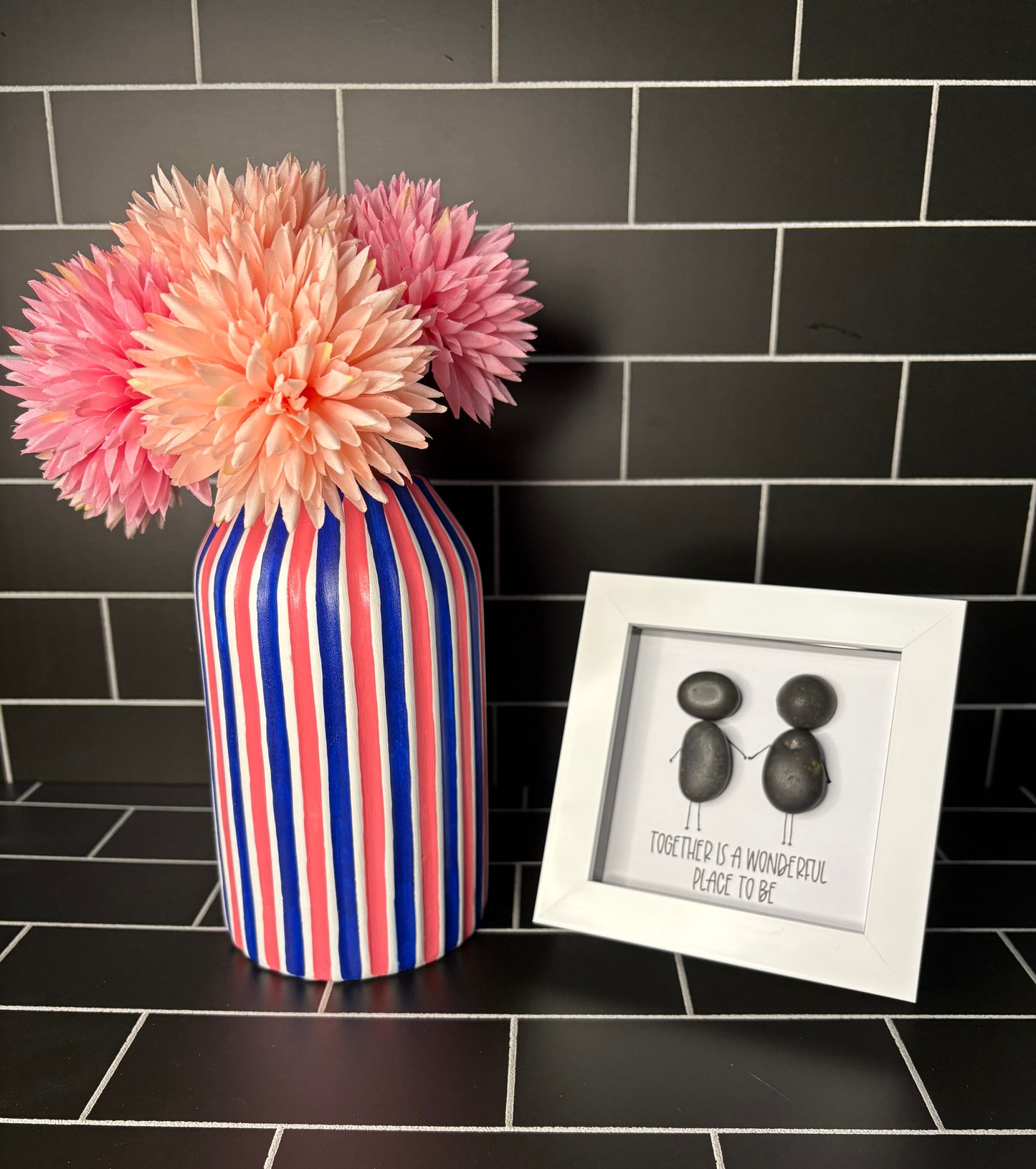 A hand painted white, navy blue and coral pink striped vase, accompanied by a small pebble art frame containing the phrase 'Together Is A Wonderful Place To Be'