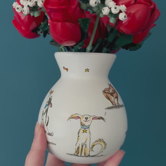 Video of a ceramic bulb vase with dogs added using decoupage napkin technique