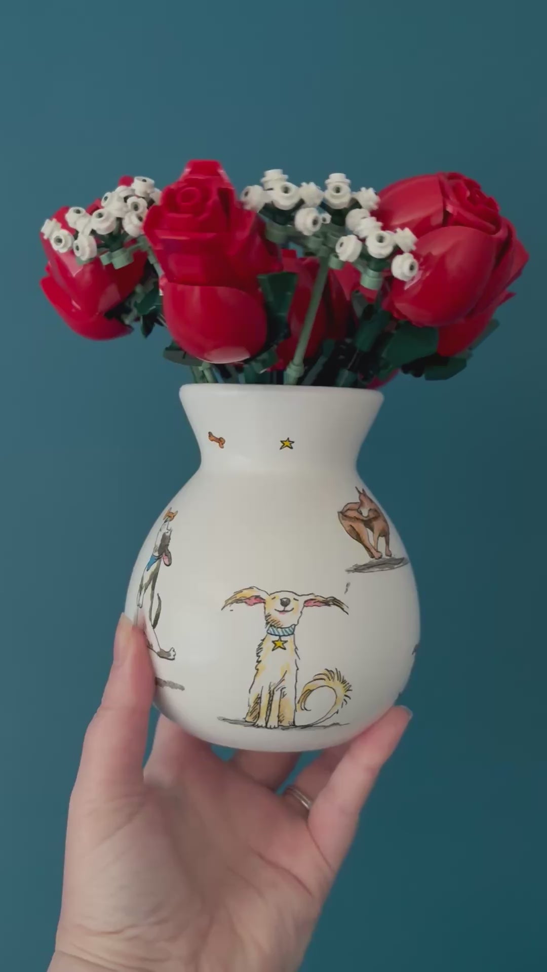 Video of a ceramic bulb vase with dogs added using decoupage napkin technique